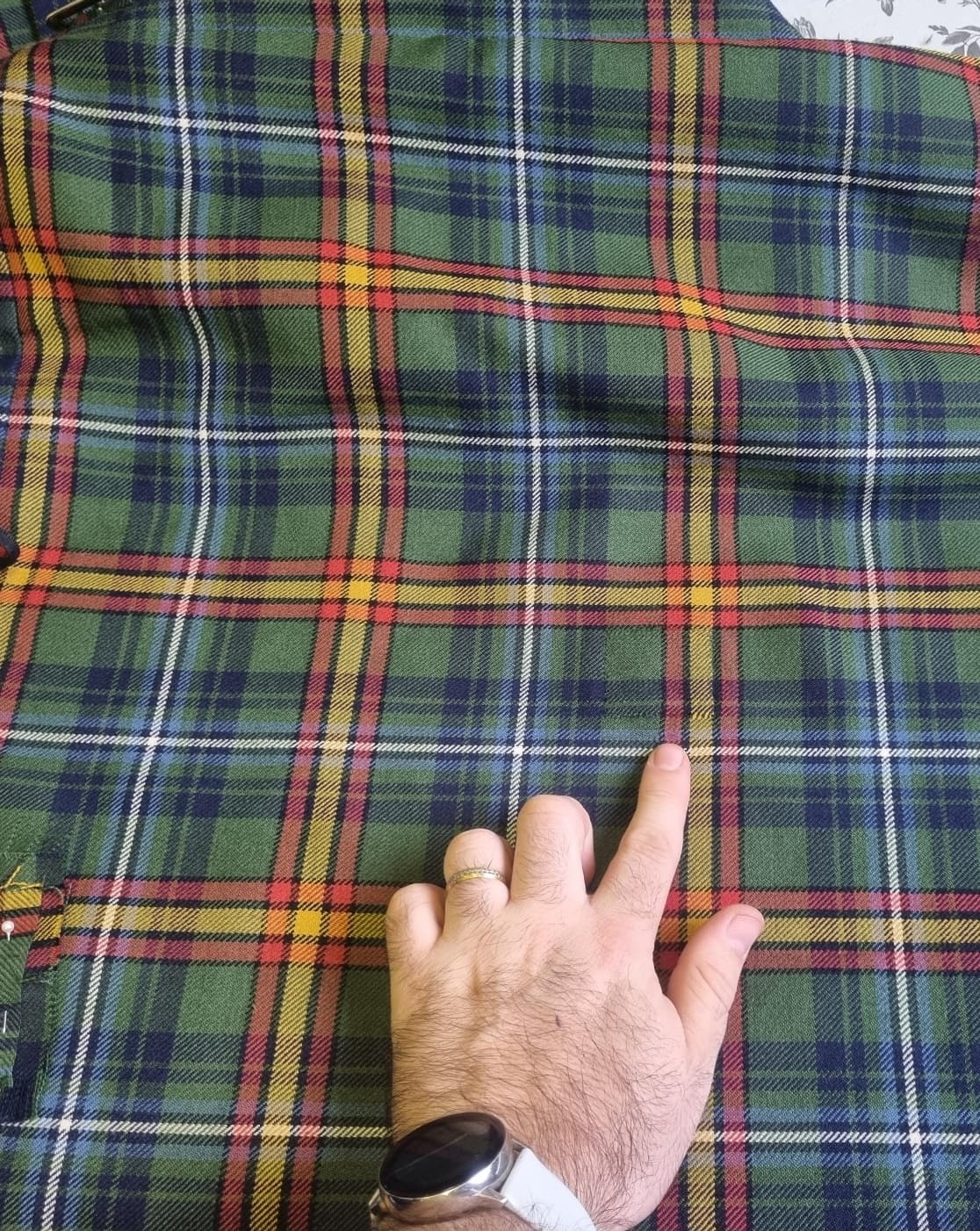 Green tartan kilt fabric after invisible reweave repair by Ault Kilts in Glasgow.